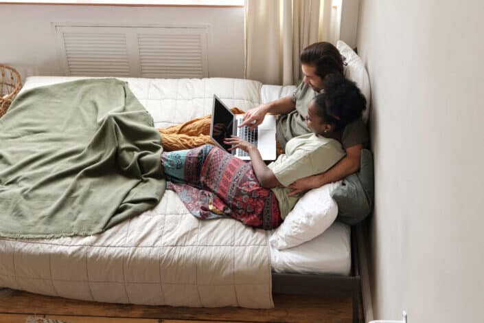 Couple in bed with a laptop