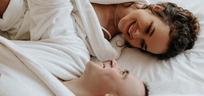 Couple lying in bed in dressing gowns