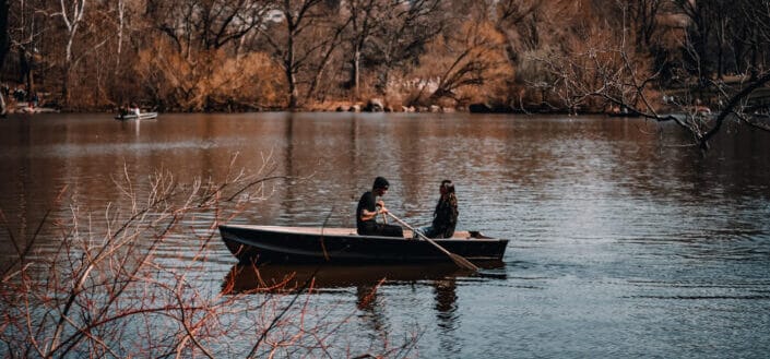 Couple Sitting in Boat Floating on a Lake