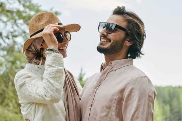 Couple wearing sunglasses laughing