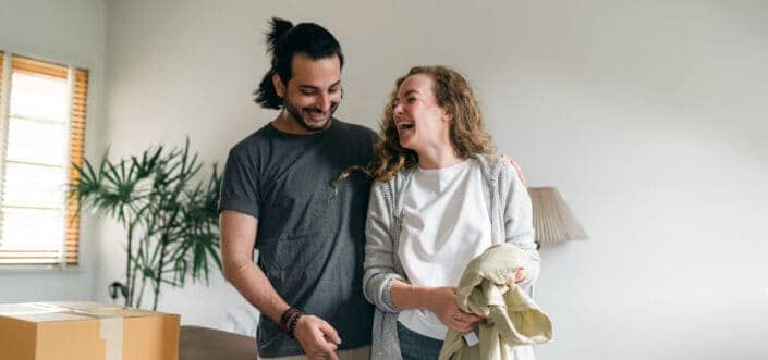 Excited couple unpacking boxes