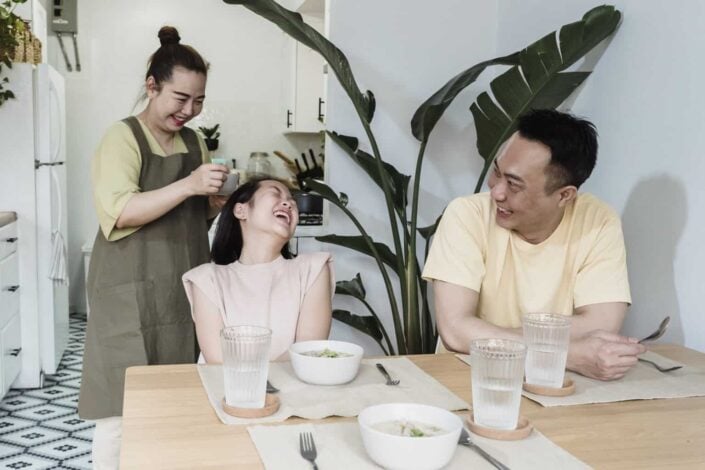 Family laughing during breakfast