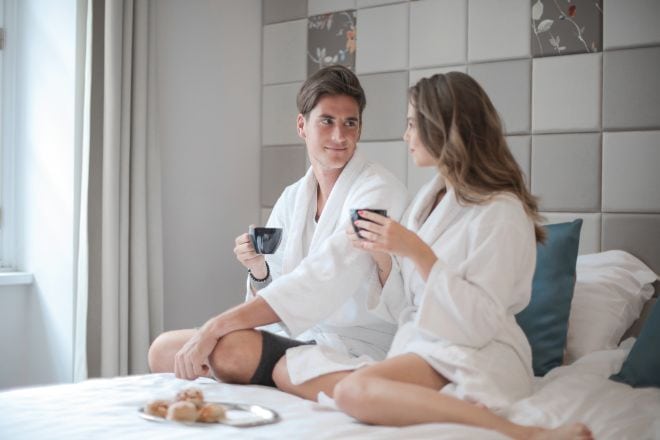 Couple Wearing Bathrobe Having Breakfast in Bed - Freaky Questions To Ask Your Girlfriend