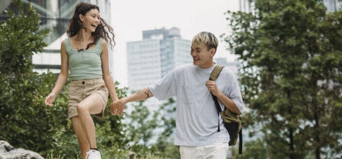 asian couple laughing and holding hands