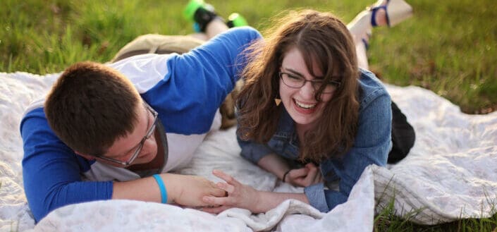 happy couple lying on blanket having a picnic