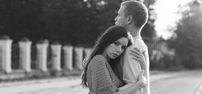 couple embracing each other on the street