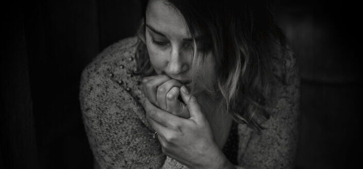 Stressed woman biting her nails