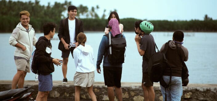 Group of People Standing Near Body of Water