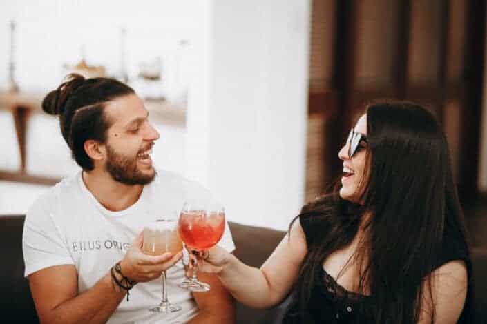 Couple laughing while having a toast