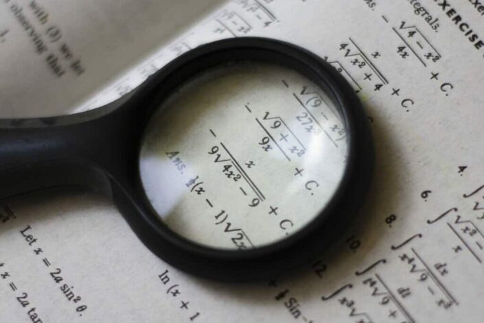 Magnifying glass on textbook