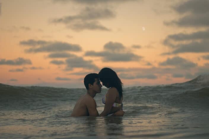 Man and Woman Hugging in The Ocean