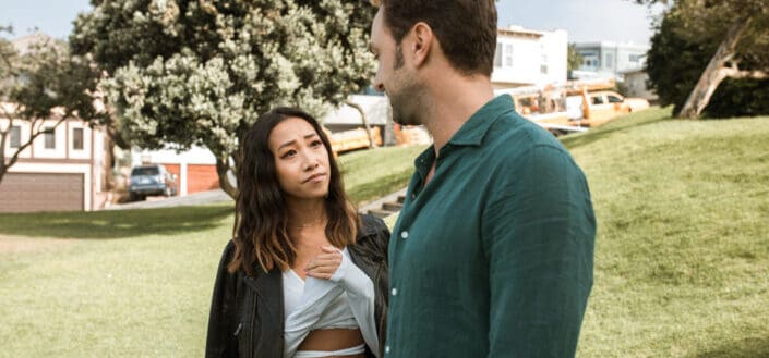 Couple staring at each other while in park