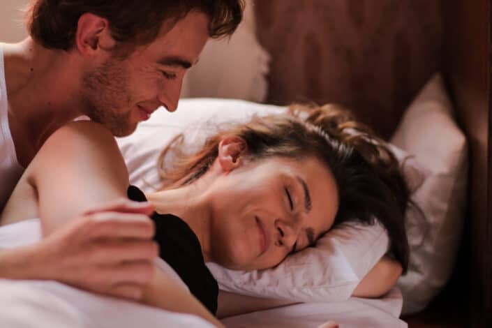 Man and woman lying on bed