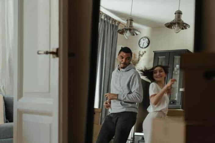 Couple having some fun dancing together in their living room