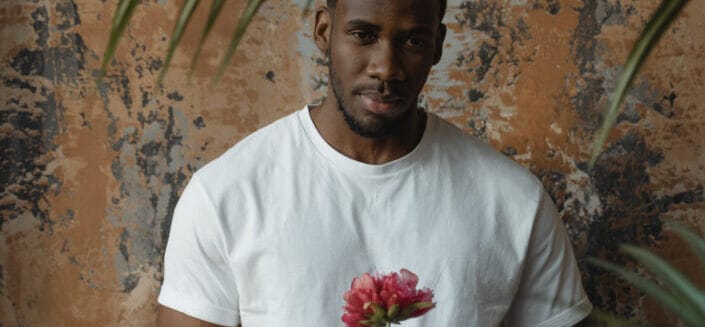 Man holding a delicate flower