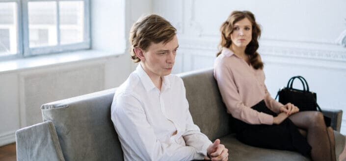 Man Sitting Beside a Woman on a Couch