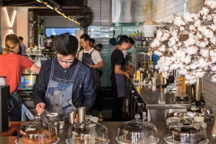 baristas working at a busy cafe