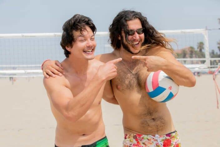 men playing beach volley together