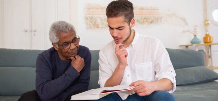 Men Reading a Book With Grandparent