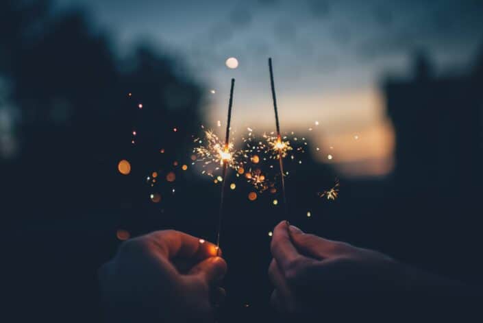 Sparklers being held by two hands
