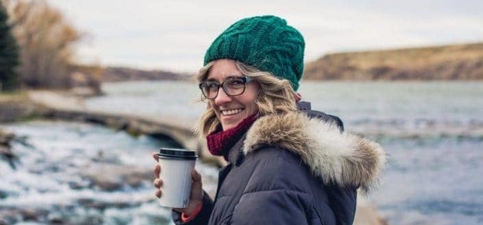 a woman dressed in winter clothes smiling