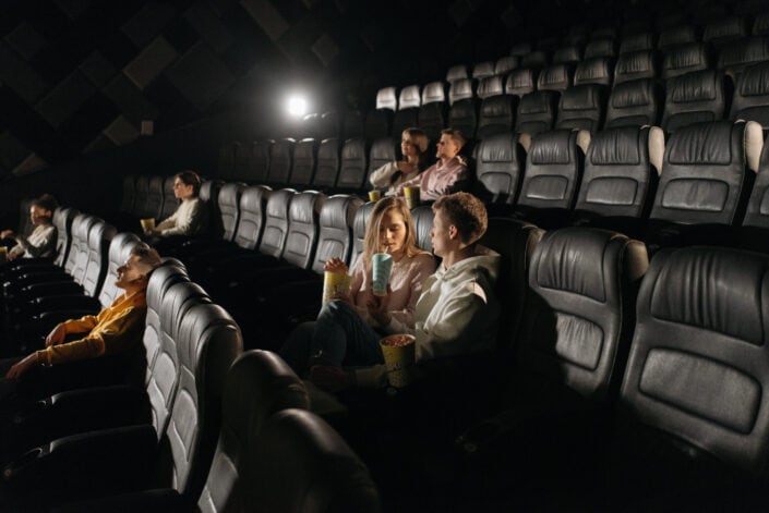People sitting inside a movie theater