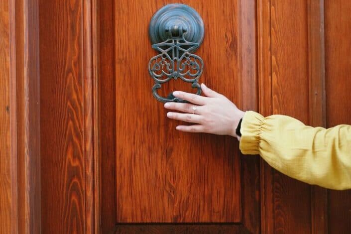 Person holding a door knocker