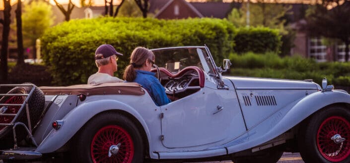 Couple sitting in an old car