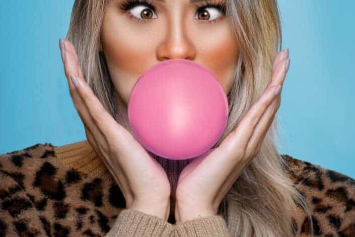 Woman Blowing a Pink Bubble Gum