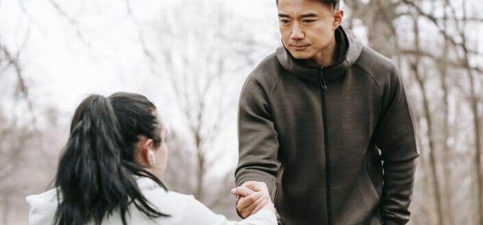 man giving hand to woman