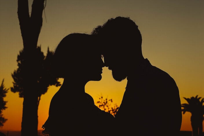 Silhouette of couple kissing during sunset