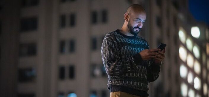 Man using a phone at night