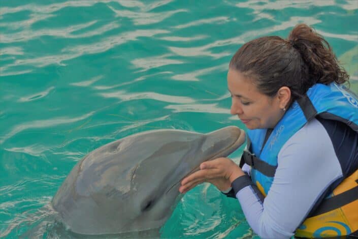 woman playing with dolphin