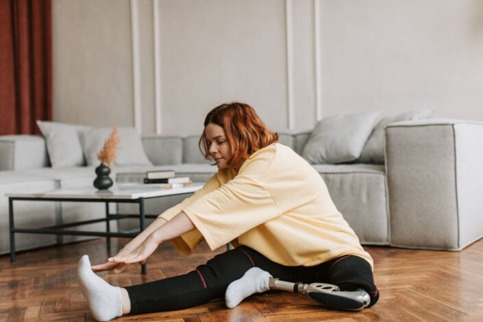 Woman exercising while sitting on the floor