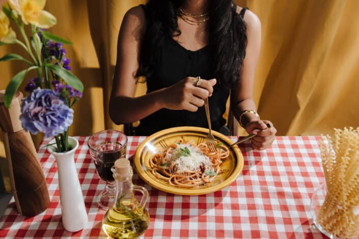 Woman Eating a Plate of Bolognese