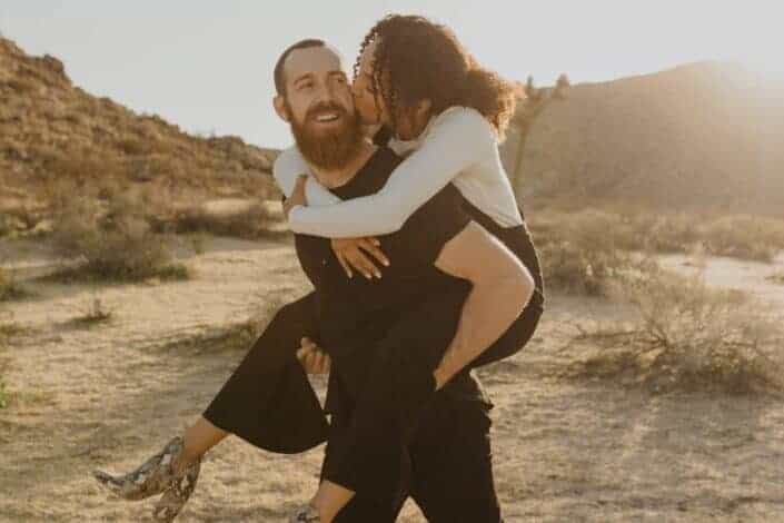 Woman kissing her man in the cheeks