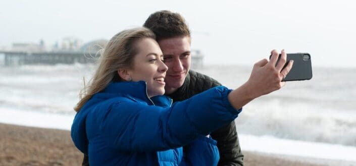Couple taking a selfie beside the beach
