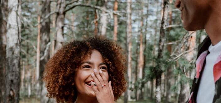 Woman timidly laughing over the guy's joke