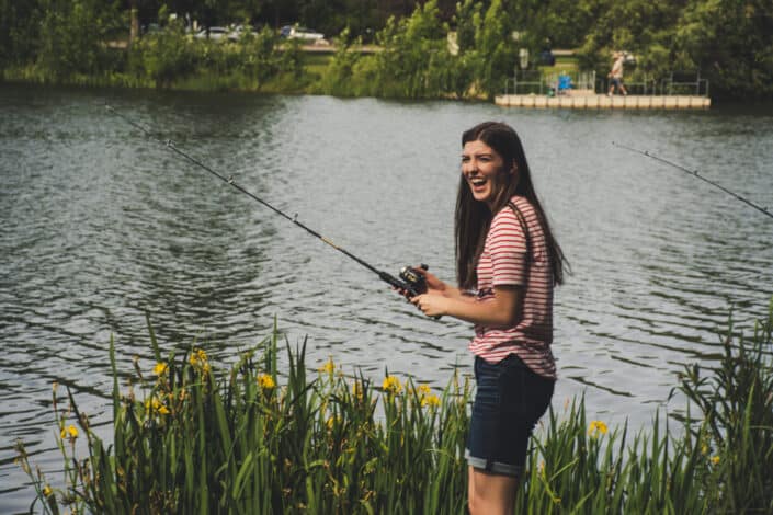 Woman Holding a Fishing Rod By The Lake