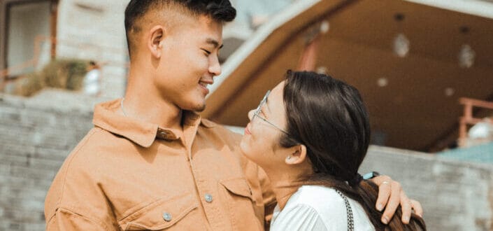 Couple smiling at each other while hugging