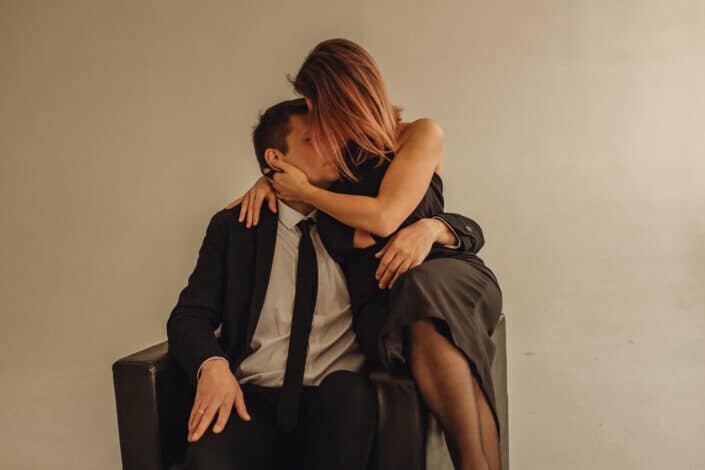Woman kissing a man on sofa