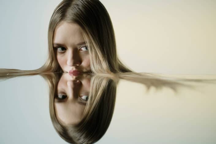 Woman resting her lips on mirror