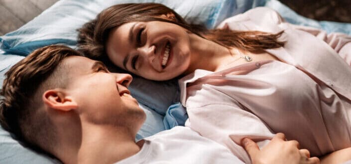 Young couple lying on bed