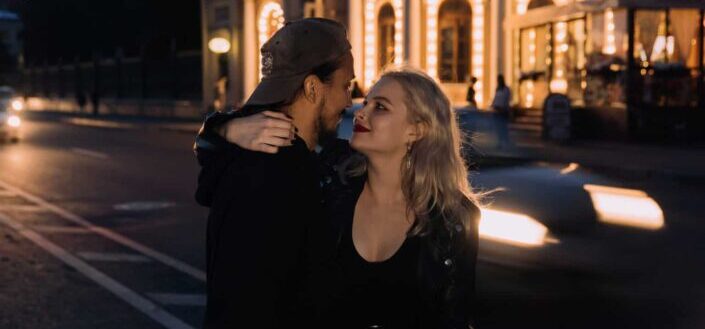 couple embracing while standing on the street