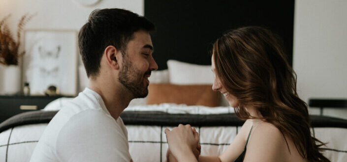 couple sitting on the floor holding hands