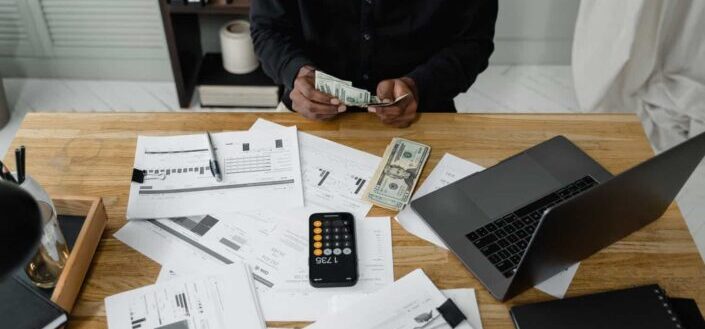 A person counting dollar bills