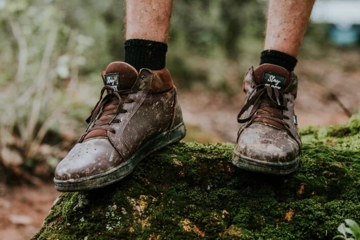 A person wearing muddy shoes