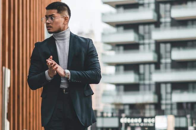 Man in black suit standing on sidewalk - Alpha Male Quotes