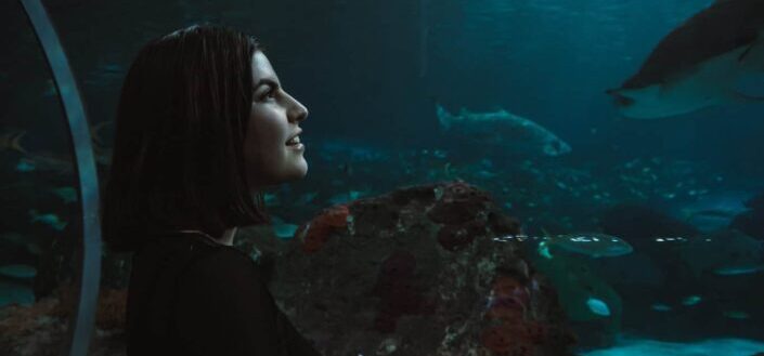 woman inside an aquarium tunnel