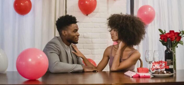 Couple Celebrating While Having Conversation at Table